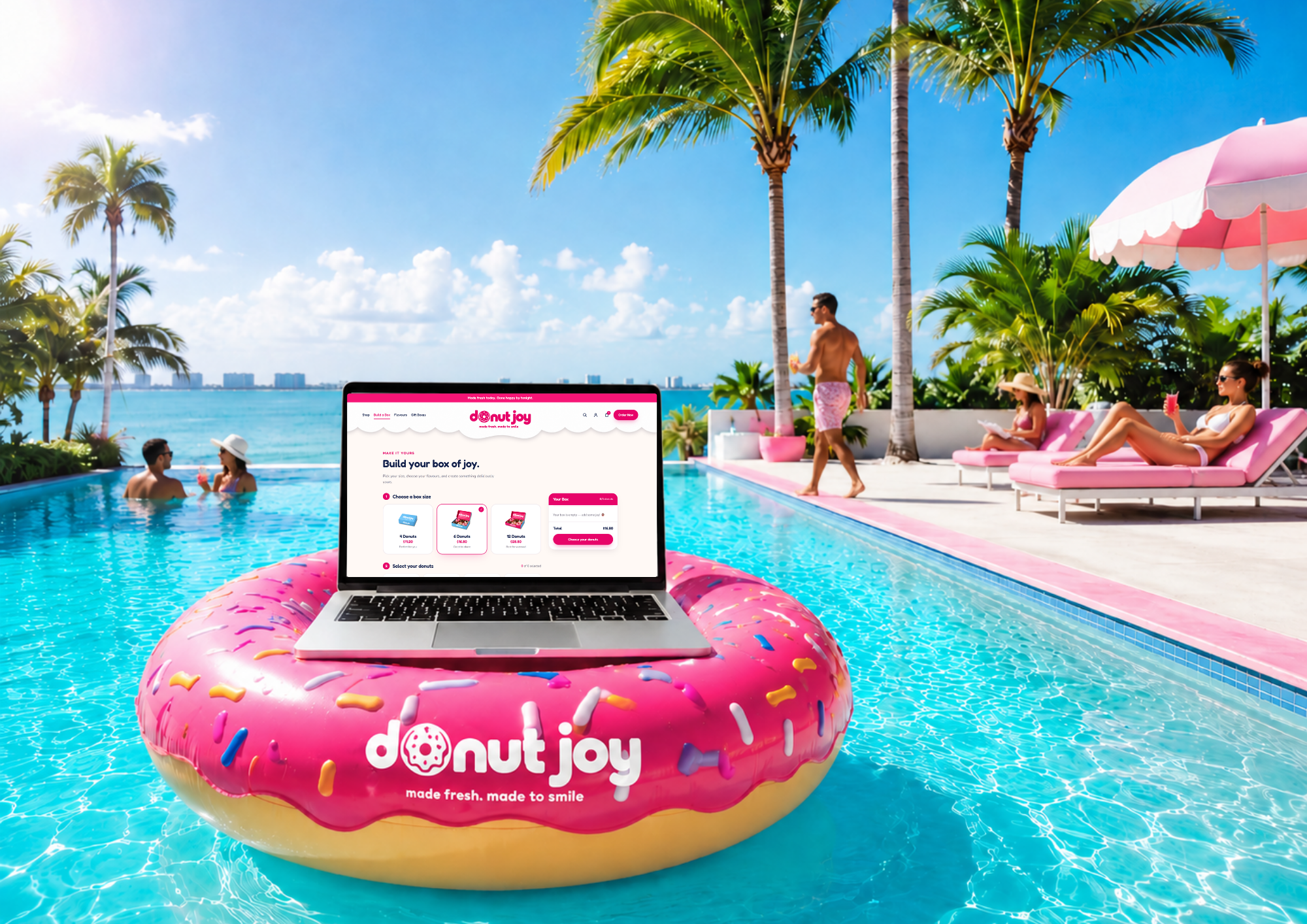 The Donut Joy Build a Box page on a laptop resting on a donut pool float